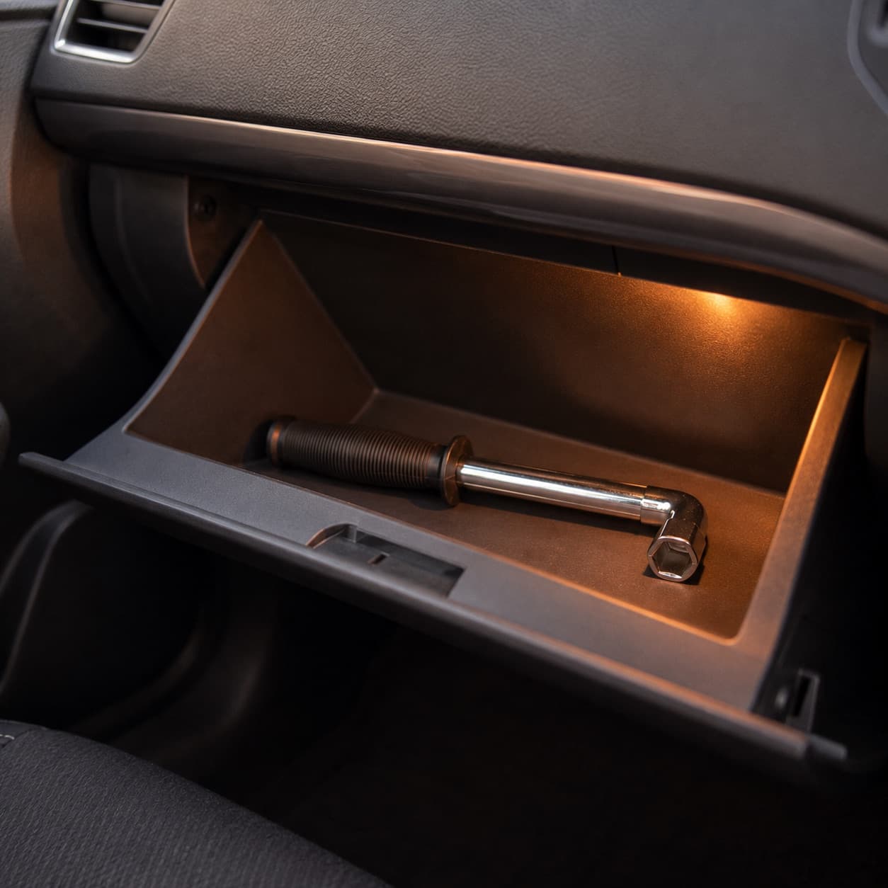 Folded wrench resting in a glove box